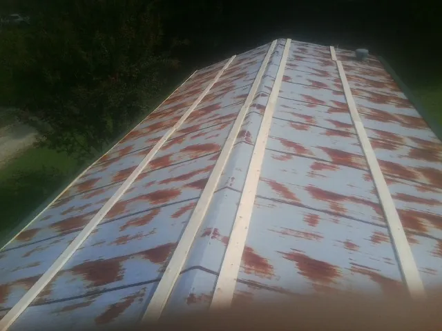 Rusted metal roof panels with new wood purlins before replacement — Storm Damage Roof Repair in Trion by Roofing Brothers