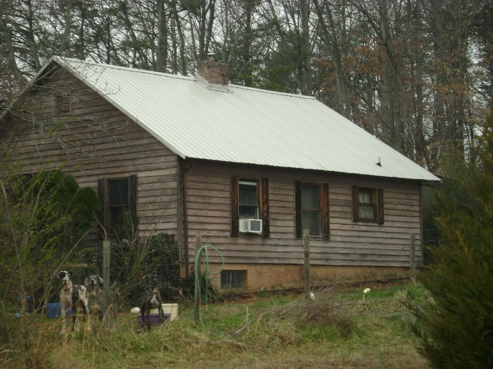 White metal roof on an old wood sided farmhouse, from a Metal Roof Installation job in Trion
